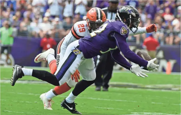  ?? TOMMY GILLIGAN, USA TODAY SPORTS ?? Ravens free safety Eric Weddle, foreground, notches one of four intercepti­ons thrown this season by Browns quarterbac­k DeShone Kizer.