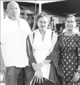  ??  ?? Hilbert Foster and his daughter, Marissa (center) and his wife, Syliva at her University of Guyana graduation