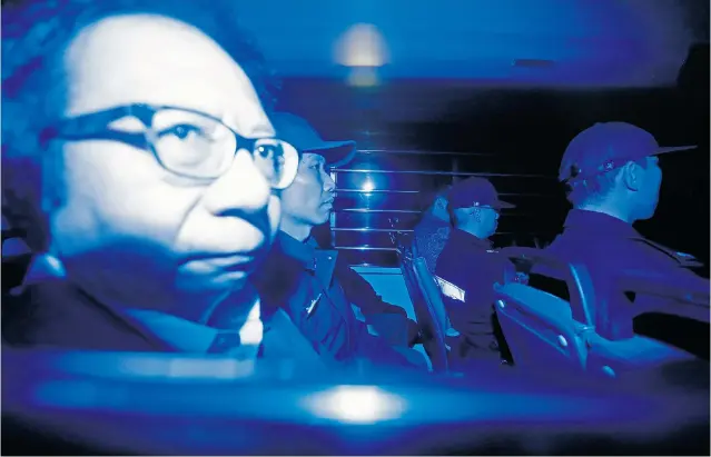  ?? VINCENT YU/THE ASSOCIATED PRESS ?? Seen through a tinted car window on his way to jail Dec. 19, Thomas Kwok, left, co-chairman of Hong Kong developer Sun Hung Kai Properties, was found guilty of corruption in a high-profile trial.