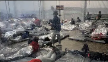  ?? AP
Photo courtesy of the Office of Rep. Henry Cuellar via ?? This March 20 photo provided by the Office of Rep. Henry Cuellar, D-Texas, shows detainees in a Customs and Border Protection (CBP) temporary overflow facility in Donna, Texas.