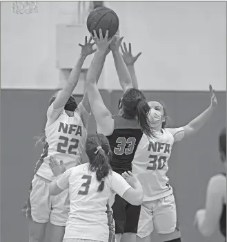  ?? SEAN D. ELLIOT/THE DAY ?? Fitch forward Alyssa Virtue shoots over NFA defenders Sarah Ericson (22) and Caitlin Daley (30) in Friday night’s ECC South Division girls’ basketball game in Norwich.