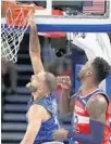  ?? JOHN RAOUX/AP ?? The Orlando Magic’s Evan Fournier, left, makes a shot in front of the Washington Wizards’ Jeff Green on Friday night.