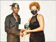  ?? ?? Dancehall artiste One Dan receiving the People’s Choice Awards from a member of the Region 10 Tourism Committee, Cassandra Crawford. (Photo by Area 42)