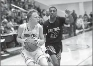  ?? NWA Democrat-Gazette/CHARLIE KAIJO ?? Rogers freshman guard Will Liddell (left) pulls up for a shot in front of Little Rock Central sophomore guard Corey Camper during the Mounties’ victory Thursday. Liddell scored 14 points as the Mounties won a state tournament game for the first time since 2011.