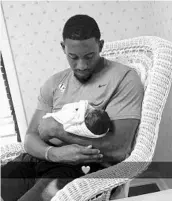  ?? COURTESY OF MEGAN BURKETT/SNAPCHAT ?? UCF linebacker Chequan Burkett holds his son in an Alabama hospital. Burkett left camp to go meet his new child.