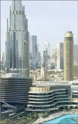  ?? (AP) ?? Smoke fills the sky in downtown Dubai from a fire on Wednesday, April 27, 2022. A large fire erupted at a luxury hotel, forcing guests and staff to leave and sending smoke over the United Arab Emirates’ tourism and trade hub.