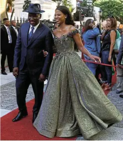  ?? Picture: Esa Alexander ?? Bheki Cele is escorted by wife Thembeka Ngcobo before President Cyril Ramaphosa’s maiden Sona speech in parliament. Ngcobo’s outfit, like others on the red carpet that year, reflected the optimism of ’the dawn of a new golden era’.