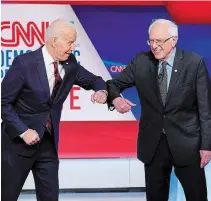  ?? EVAN VUCCI THE ASSOCIATED PRESS FILE PHOTO ?? The latest policy announceme­nts by Joe Biden, left, are aimed at winning over supporters of Bernie Sanders and bridging the Democratic Party’s ideologica­l divide in time for the election.