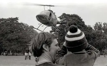  ?? Photo: Bruce Mackenzie ?? TAKE OFF: A father and son enjoy the entertainm­ent at Queens Park during the 1982 Toowoomba Carnival of Flowers.