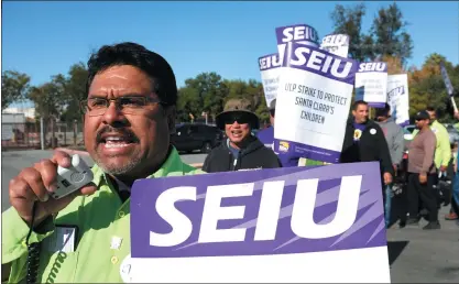  ?? ?? Santa Clara County employee Robert Barragan leads pickets outside the Roads and Airports yard on Schallenbe­rger Road after thousands of county workers went on strike Wednesday in San Jose.
