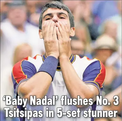  ?? Corey Sipkin ?? HIT TSI’ BABY ONE MORE TIME: Carlos Alcaraz (left) is overcome with emotion after ousting third-seeded Stefanos Tsitsipas during the third round of the U.S. Open on Friday at Arthur Ashe Stadium.