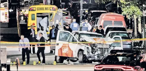  ??  ?? CHAOS: Authoritie­s investigat­e the damaged Home Depot rental truck that a terrorist used to kill eight people in Manhattan on Tuesday.