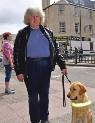  ??  ?? John McQuade with his guide dog Simpson at Combie Street in Oban.