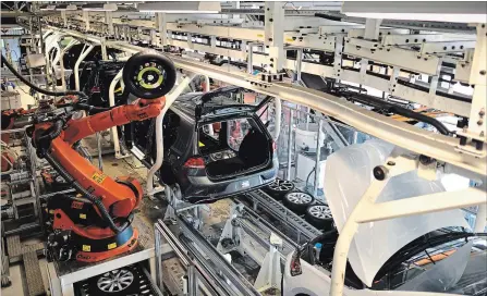  ?? ALEXANDER KOERNER GETTY IMAGES ?? Volkswagen cars move along an assembly line. The OECD says the global economy will expand by 3.9 per cent this year and in 2019.