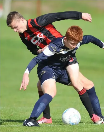  ??  ?? Finn Kelly, Ardee Celtic holds off a challenge from Conor Doris, Bellurgan.