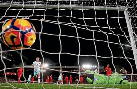  ??  ?? West Ham United’s Dimitri Payet scores their first goal past Liverpool’s Loris Karius in a 2-2 draw at Anfield.