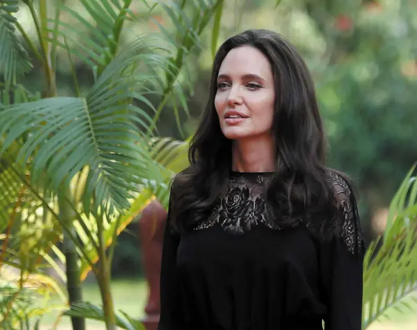  ??  ?? ON A ‘JOURNEY’: Angelina Jolie in Cambodia last week. She’s gone from wild child to earth mother to UN activist. Photo: Samrang Pring/Reuters