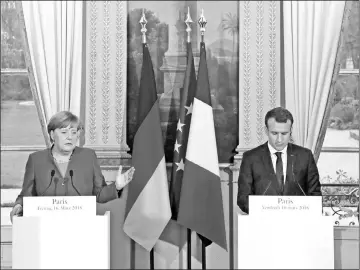  ??  ?? Macron (right) and Merkel give a joint press conference at the Eylsee presidenti­al Palace in Paris. — Reuters photo