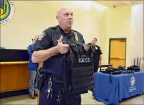  ?? Will Waldron / Times Union ?? Chief John Jonathan Teale displays a protective vest in 2017. Under his tenure, police force staffing has become the largest it has ever been.