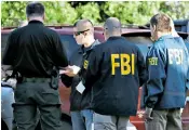  ??  ?? FBI agents at the scene of the Fedex bomb blast as forensics officers comb the streets of Austin in search of clues in the hunt for a serial bomber