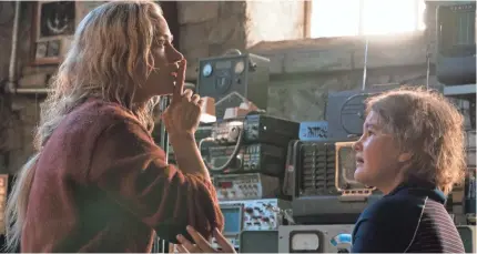  ?? JONNY COURNOYER ?? Evelyn (Emily Blunt) implores her daughter, Regan (Millicent Simmonds), to remain quiet in thriller “A Quiet Place.”