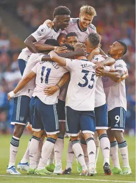  ?? ?? Arsenal players celebrate a goal in a Premier League match against Crystal Palace.