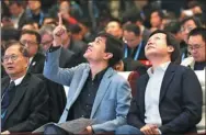  ?? ZOU HONG / CHINA DAILY ?? Robin Li (front center), CEO of Baidu Inc, and Lei Jun (front right), founder and CEO of Xiaomi Corp, at the 4th World Internet Conference in Wuzhen, Zhejiang province.