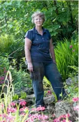  ??  ?? Trish Maycock on the rocky slopes of the Cotswold bog garden she has lovingly brought back to life.