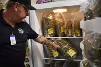  ?? AP PHOTO/MATTHEW BROWN ?? Montana Advanced Caregivers owner Richard Abromeit talks about different strains of marijuana stored in a refrigerat­or at the Billings, Mont., medical marijuana dispensary on Nov. 11.