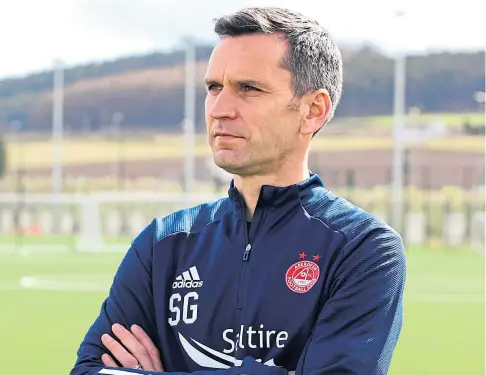  ??  ?? GETTING TO WORK: New Aberdeen boss Stephen Glass had his first day with the players on the training ground.