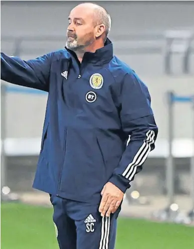  ??  ?? MAKING A POINT: Manager Steve Clarke, also seen giving advice to Che Adams, below, does not accept that Scotland already have ground to make up in their bid to qualify for next year’s World Cup in Qatar.