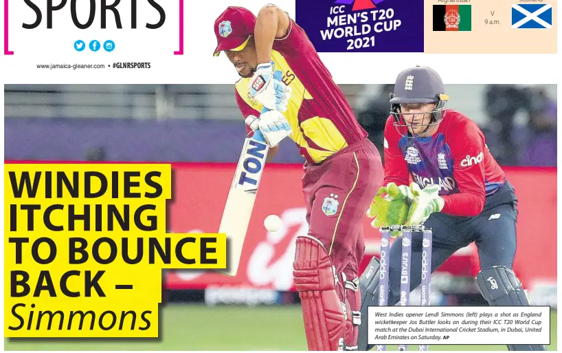  ?? AP ?? West Indies opener Lendl Simmons (left) plays a shot as England wicketkeep­er Jos Buttler looks on during their ICC T20 World Cup match at the Dubai Internatio­nal Cricket Stadium, in Dubai, United Arab Emirates on Saturday.