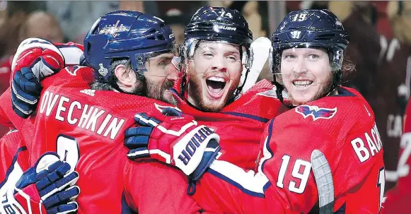  ?? THE ASSOCIATED PRESS ?? Capitals defenceman John Carlson, centre, celebrates with teammates Alex Ovechkin and Nicklas Backstrom after scoring against the Golden Knights on Monday.