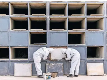  ?? FOTO: DPA ?? Arbeiter in Schutzanzü­gen auf einem Friedhof in Rio. Die Zahl der Corona-Todesfälle steigt in Brasilien stark.