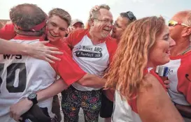  ?? JIM WEBER/THE COMMERCIAL APPEAL ?? Mark West, center and members of the 10 Bones BBQ team celebrate after winning the rib division for a third time at the 2018 Memphis in May World Championsh­ip Barbecue Cooking Contest at Tom Lee Park. 10 Bones is competing in Smokeslam this year.