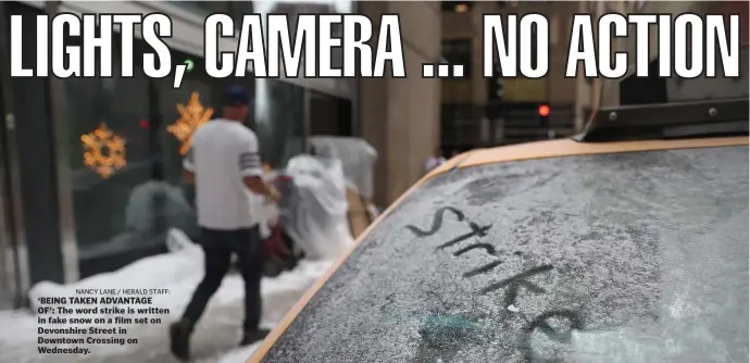  ?? NAncy lAnE / hErAld stAFF: ?? ‘BEING TAKEN ADVANTAGE OF’: The word strike is written in fake snow on a film set on Devonshire Street in Downtown Crossing on Wednesday.