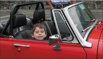  ??  ?? 3 year old Niall Dolan behind the wheel of his Grandad Joe Dolan’s 1975 MG Midget.