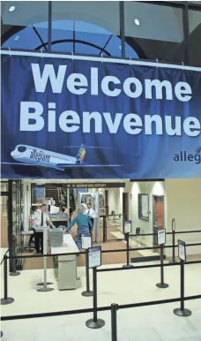  ??  ?? An Allegiant sign welcomes travelers in English and French.