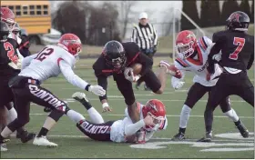  ?? GEORGE POHLY — THE MACOMB DAILY ?? Deion Black of Michigan Collegiate is tripped up after running for a first down during a Division 6 regional championsh­ip game against Clinton.