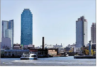  ?? AP ?? A water taxi approaches the Long Island City waterfront and skyline, in the Queens borough of New York near where an Amazon corporate complex will be built.