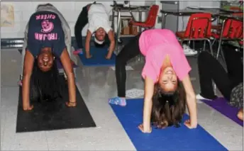  ?? MICHILEA PATTERSON — DIGITAL FIRST MEDIA ?? Students perform a flexible pose during a yoga club at the Pottstown Middle School. Area school districts are building a culture of health through wellness policies.