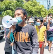  ?? AP ?? Demonstrat­ors march Saturday against the ruling junta in Yangon, Myanmar. Reports say 82 were killed Friday.