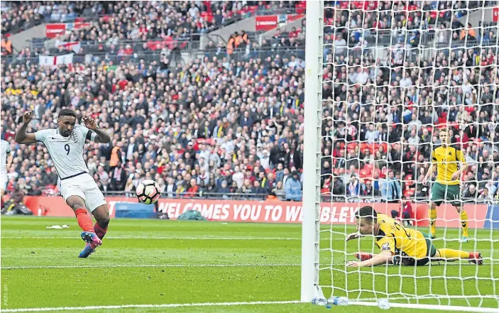  ??  ?? England’s Jermain Defoe, left, scores against Lithuania at Wembley.