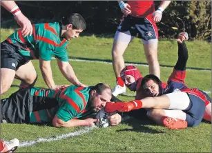  ??  ?? Oban Lorne player/coach Corrie Louw grounds the ball for the first score of the match.