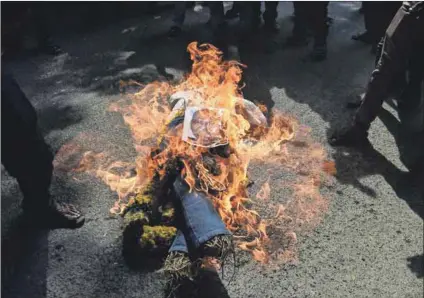  ??  ?? Anger: Indian demonstrat­ors burn an effigy of Vedanta Resources boss Anil Agarwal because of the killings of at least 10 people during a protest about pollution from a copper factory. Photo: Arun Sankar/AFP