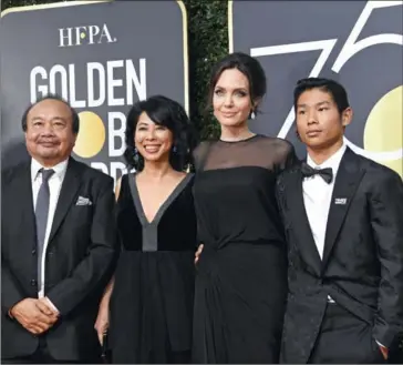  ??  ?? Pax Jolie-Pitt (right), Angelina Jolie, activist Loung Ung (second left), and filmmaker Rithy Panh arrive for the 75th Golden Globe Awards on Sunday in Beverly Hills, California.
