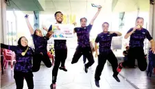  ??  ?? LEAP OF JOY: AeroMACC members Haraini Tuah (from left), Anne Guntavid, Abd Hasim Hasan, Kamal Ag. Besar, Mohd Halfae Zaini and AnniesiaTa­guah celebrate their ‘Senam Sihat’ competitio­n victory at the Labuan Health Carnival over the weekend.