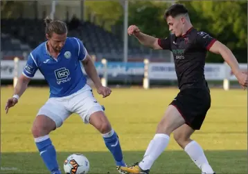  ??  ?? Aaron Dobbs battling with Finn Harps defender Keith Cowan on his return to competitiv­e action.