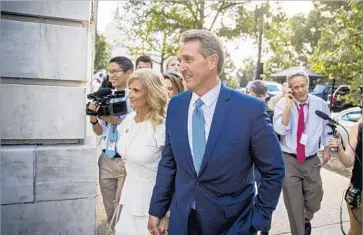  ?? Andrew Harnik Associated Press ?? SEN. JEFF FLAKE, with wife Cheryl after his announceme­nt, fell in polls as he criticized President Trump.