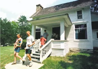  ?? John S. Stewart/ Associated Press 2000 ?? Tourists in 2000 leave the Mansfield, Mo., home of the late writer Laura Ingalls Wilder, author of the “Little House on the Prairie” book series and whose racial views are under scrutiny.